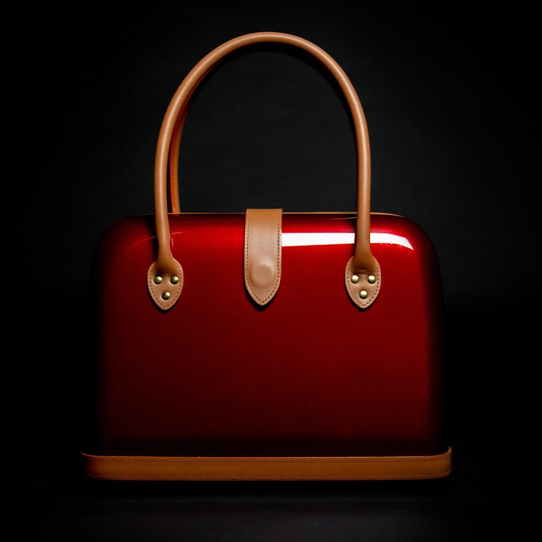 Rote Handtasche mit braunen Details als Produktaufnahme